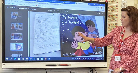 Kirstin McNeil speaking to children at school with a powerpoint presentation